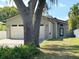 An eye-level shot of the home's front exterior with the garage on the left at 1213 Richmond Rd, Winter Park, FL 32789