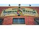 Outdoor shot of the sign for the Winter Park Farmer's Market with a brick facade and established date at 1213 Richmond Rd, Winter Park, FL 32789