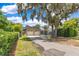Charming home featuring a two-car garage and a long driveway, shaded by mature trees at 1213 Richmond Rd, Winter Park, FL 32789