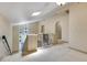 Elegant hallway with neutral carpet, wrought iron railing, and plenty of natural light from the skylight at 1213 Richmond Rd, Winter Park, FL 32789