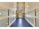 Inviting hallway with detailed wainscoting and hardwood floors leading to the entrance at 1213 Richmond Rd, Winter Park, FL 32789