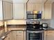 Close up of kitchen featuring oven, microwave and granite counters at 1213 Richmond Rd, Winter Park, FL 32789