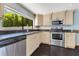 Kitchen featuring stainless steel appliances, granite countertops and a large window at 1213 Richmond Rd, Winter Park, FL 32789