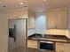 Kitchen area featuring stainless refrigerator, wine cooler and granite counters at 1213 Richmond Rd, Winter Park, FL 32789