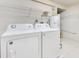 Functional laundry room with washer, dryer, and storage shelves, providing convenience and organization at 1213 Richmond Rd, Winter Park, FL 32789