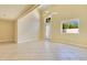 Bright living room featuring tile floors, a ceiling fan, and natural light from a door and windows at 1213 Richmond Rd, Winter Park, FL 32789