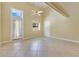 Bright living room featuring tile floors, a ceiling fan, and natural light from a door and windows at 1213 Richmond Rd, Winter Park, FL 32789