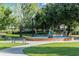 Serene park with water fountain, benches, and lush green grass along a peaceful sidewalk at 1213 Richmond Rd, Winter Park, FL 32789