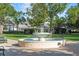 Picturesque park with a circular fountain, mature trees, benches, and walking path at 1213 Richmond Rd, Winter Park, FL 32789