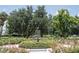 Picturesque park view featuring fountain with peacock statue, flowers, and mature trees at 1213 Richmond Rd, Winter Park, FL 32789