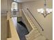 Staircase with carpet and wrought iron railing with view to the front door at 1213 Richmond Rd, Winter Park, FL 32789