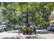 Quaint street view with decorative signs, street lamps, potted flowers and tree lined brick road at 1213 Richmond Rd, Winter Park, FL 32789