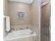 Relaxing bathroom with a soaking tub and a glass-enclosed shower at 124 Canterbury Bell Dr, Oviedo, FL 32765