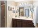 Bathroom vanity with double sinks, a large mirror, and modern lighting fixtures at 124 Canterbury Bell Dr, Oviedo, FL 32765