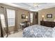 Comfortable bedroom featuring a tray ceiling, dresser, and an inviting decorative theme at 124 Canterbury Bell Dr, Oviedo, FL 32765