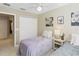 Cozy bedroom featuring neutral walls, closet, and charming decor with natural light at 124 Canterbury Bell Dr, Oviedo, FL 32765