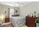 Well-lit bedroom with neutral walls, a window, and warm wood furniture at 124 Canterbury Bell Dr, Oviedo, FL 32765