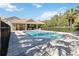 Sparkling community pool area with shaded pavilion, tables, and sun loungers at 124 Canterbury Bell Dr, Oviedo, FL 32765