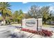 Welcome to Oviedo Park: A community entrance sign surrounded by colorful landscaping at 124 Canterbury Bell Dr, Oviedo, FL 32765