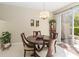 Bright dining area with a round table, pendant lighting, and sliding glass door access to the patio at 124 Canterbury Bell Dr, Oviedo, FL 32765