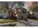 Charming townhome featuring a well-maintained lawn, two-car garage, and lovely architectural details at 124 Canterbury Bell Dr, Oviedo, FL 32765