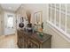 Welcoming foyer with tiled floor and an accent table next to the stairway at 124 Canterbury Bell Dr, Oviedo, FL 32765