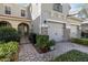 Inviting front entrance with brick pavers, a gated courtyard, and well-manicured landscaping at 124 Canterbury Bell Dr, Oviedo, FL 32765