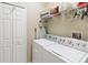 Functional laundry room featuring a washer, dryer, and plenty of storage space at 124 Canterbury Bell Dr, Oviedo, FL 32765