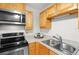 Close-up of kitchen with stainless steel appliances and solid surface countertops at 1317 S Pine Ridge Cir # 1317, Sanford, FL 32773