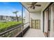 Screened patio features a ceiling fan, tiled flooring, and view of the manicured lawn and parking at 1317 S Pine Ridge Cir # 1317, Sanford, FL 32773