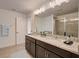 Bathroom featuring double sinks, granite countertops, and a glass-enclosed shower at 1367 Wood Line Dr, Deland, FL 32720