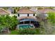 Aerial view of the property featuring a screened-in pool area and a well-maintained backyard at 1412 Moon Valley Dr, Davenport, FL 33896