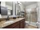 Bathroom featuring a double vanity with granite countertop and a glass enclosed shower at 1412 Moon Valley Dr, Davenport, FL 33896