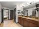 Lovely bathroom featuring double sinks, granite countertops, and neutral tile floors at 1412 Moon Valley Dr, Davenport, FL 33896