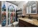 Bathroom featuring stained glass shower curtain, brick accent wall, granite countertop at 1412 Moon Valley Dr, Davenport, FL 33896