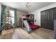 bedroom featuring bunkbeds with a built in slide and a stone accent wall at 1412 Moon Valley Dr, Davenport, FL 33896