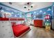 Bright bedroom with red bunk beds, colorful decor and a fun Toy Story theme at 1412 Moon Valley Dr, Davenport, FL 33896