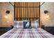 Bedroom featuring brick accent wall, an owl pillow, and custom wall lighting at 1412 Moon Valley Dr, Davenport, FL 33896