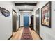 Bright foyer with wood-look floors, exposed beams, and a large blue door at 1412 Moon Valley Dr, Davenport, FL 33896