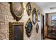 Hallway featuring antique gold framed portraits on a faux stone wall at 1412 Moon Valley Dr, Davenport, FL 33896