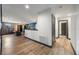 Hallway leading to finished basement with hardwood floors and view of adjacent seating area at 1412 Moon Valley Dr, Davenport, FL 33896