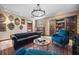 Living room features library doors, leather sofa, and faux stone walls at 1412 Moon Valley Dr, Davenport, FL 33896