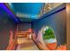 Custom ' playroom featuring built-in slide, creative decor, and whimsical lighting at 1412 Moon Valley Dr, Davenport, FL 33896