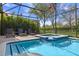 Screened-in pool and jacuzzi offer a serene escape, complemented by lush greenery and privacy at 1412 Moon Valley Dr, Davenport, FL 33896