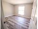 Cozy bedroom featuring durable wood-look flooring and bright natural light at 1442 S Hawthorne Ave, Apopka, FL 32703