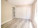 Neutral toned bedroom showcases wood-look flooring and ample closet space at 1442 S Hawthorne Ave, Apopka, FL 32703