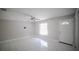 Bright living room with tile flooring, a ceiling fan, and a white entry door at 1442 S Hawthorne Ave, Apopka, FL 32703