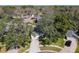 Aerial view of a charming home surrounded by mature trees and lush landscaping in a residential neighborhood at 1525 Oakwood Ct, Apopka, FL 32703