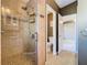 Modern bathroom featuring glass shower with neutral tile and mosaic accent wall at 1525 Oakwood Ct, Apopka, FL 32703