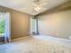 Bright bedroom featuring neutral walls, vaulted ceiling, plush carpeting, and a ceiling fan at 1525 Oakwood Ct, Apopka, FL 32703